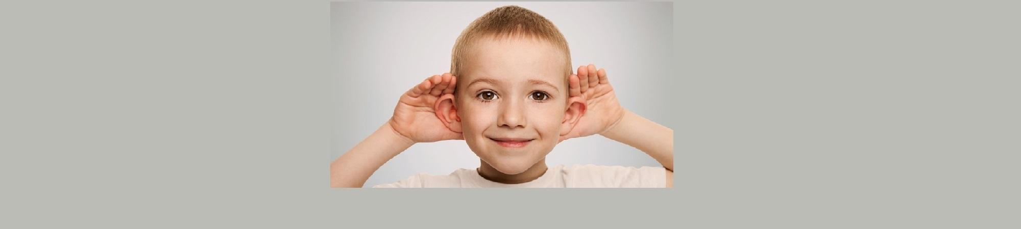 Boy cupping ears to hear better